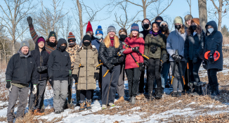 Youth volunteers with loppers during a winter brush removal workday