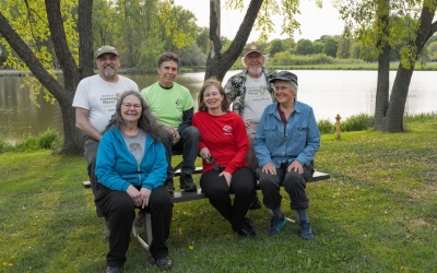 The Friends of Cherokee Marsh - 6 people smiling while sitting as a group posing for the camera 