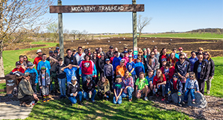 Large group of youth at McCarthy County Park standing in front of the sign