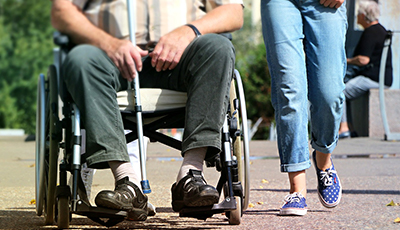 Two people side by side, one in a wheelchair
