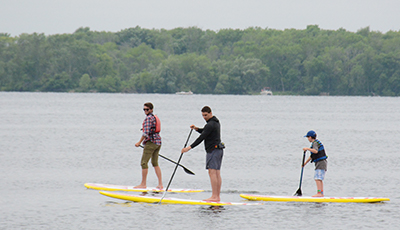 Three people paddleboarding on the lake