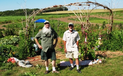 Two people standing in front of a garden at Silverwood County Park