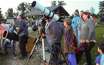 People using telescopes to look at the sky